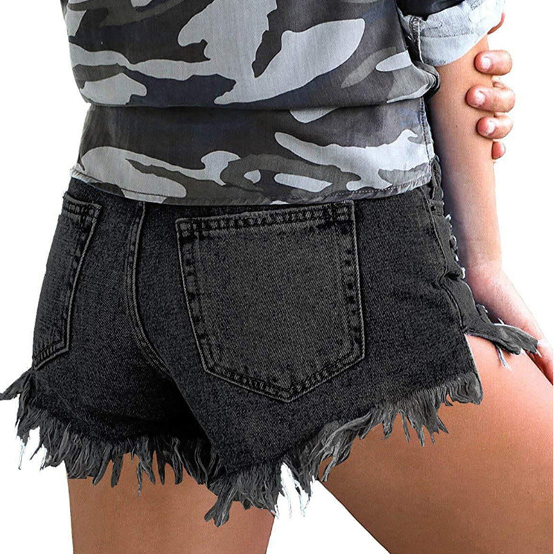 Women's Denim Shorts – High-Stretch Mid-Waist Fringed Denim shown from the back with a camo shirt.